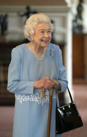 Elizabeth II portait une robe bleue clair avec un collier de perles 
