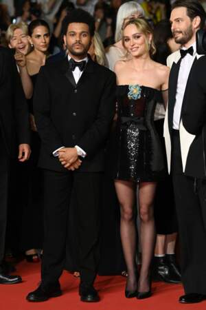 Abel Tesfaye (The Weeknd) porte un costume noir, tandis que Lily-Rose Dell a choisi une robe bustier à sequins noirs