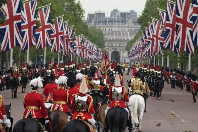 Le cortège royal se rendant dans le centre de Londres au milieu des drapeaux.